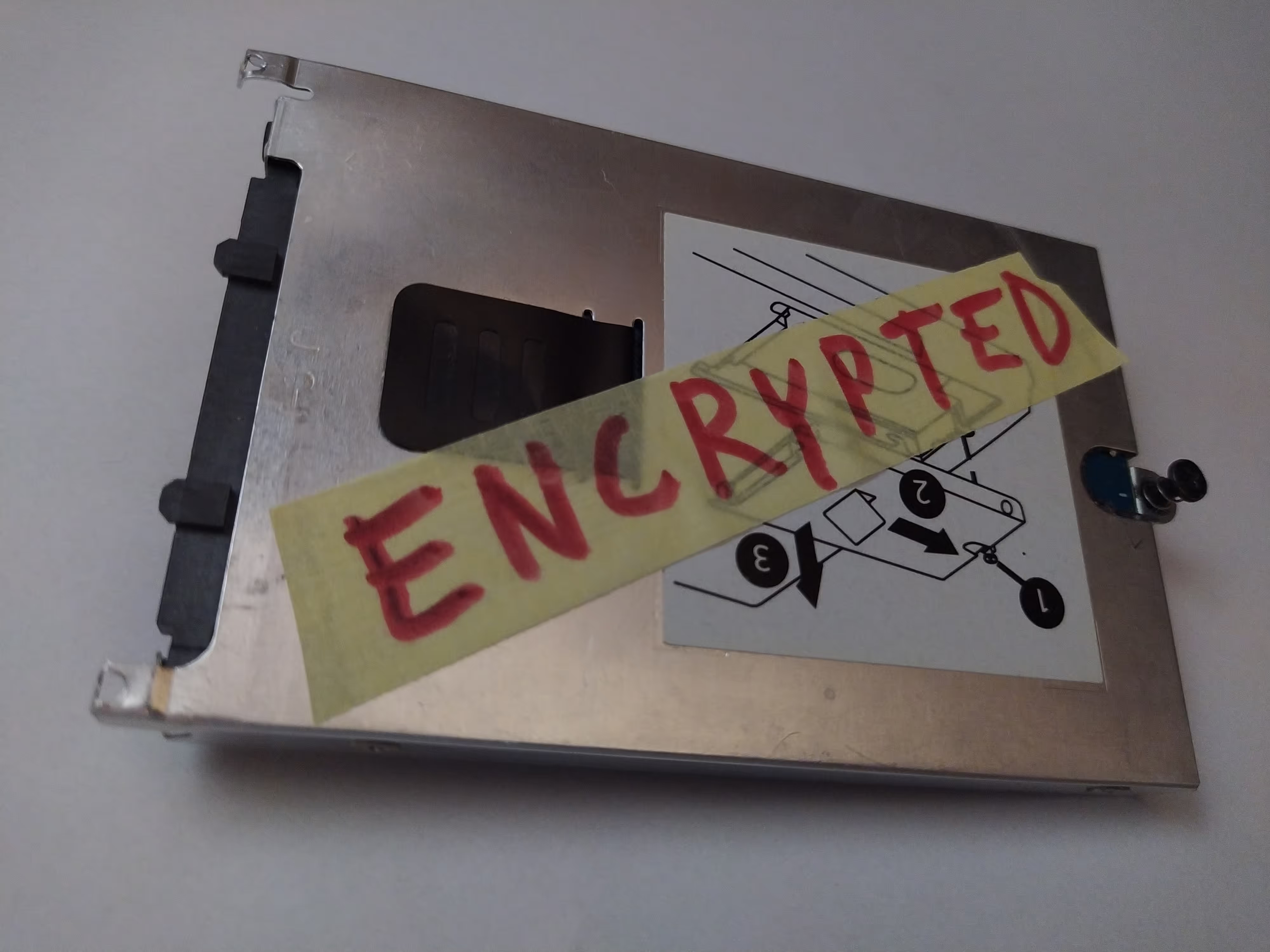 an HDD with a label on it that says "ENCRYPTED"